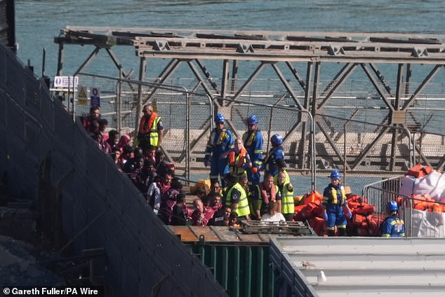 The dinghy suffered what authorities have described as a 'catastrophic deflation' 10 miles off the coast of Dover at around 12.30pm on Tuesday. Pictured: Migrants arriving at Dover