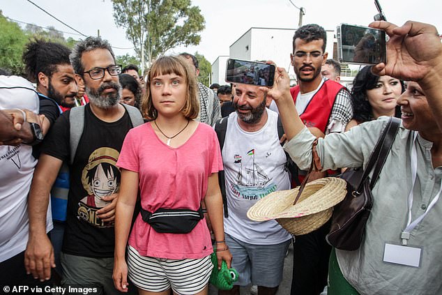 Greta Thunberg walks with a crowd of pro-Palestinian activists that arrived to greet the Global Sumud Flotilla at the port of the village of Sidi Bou Said at the weekend