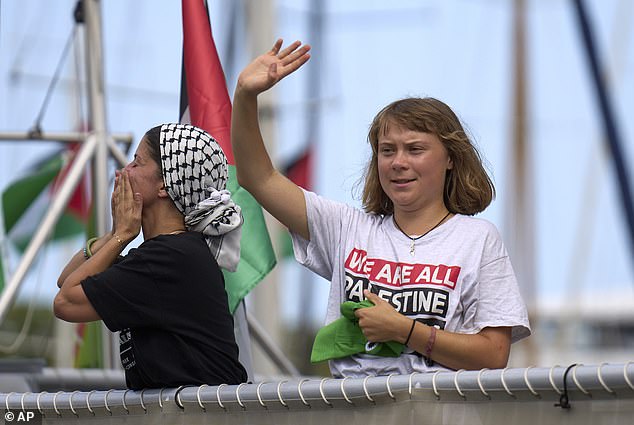 Ms Thunberg waves from a boat taking part in a civilian flotilla bound for Gaza, aiming to break the Israeli blockade