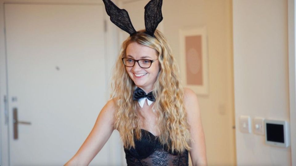 a woman wearing bunny ears and a bow tie