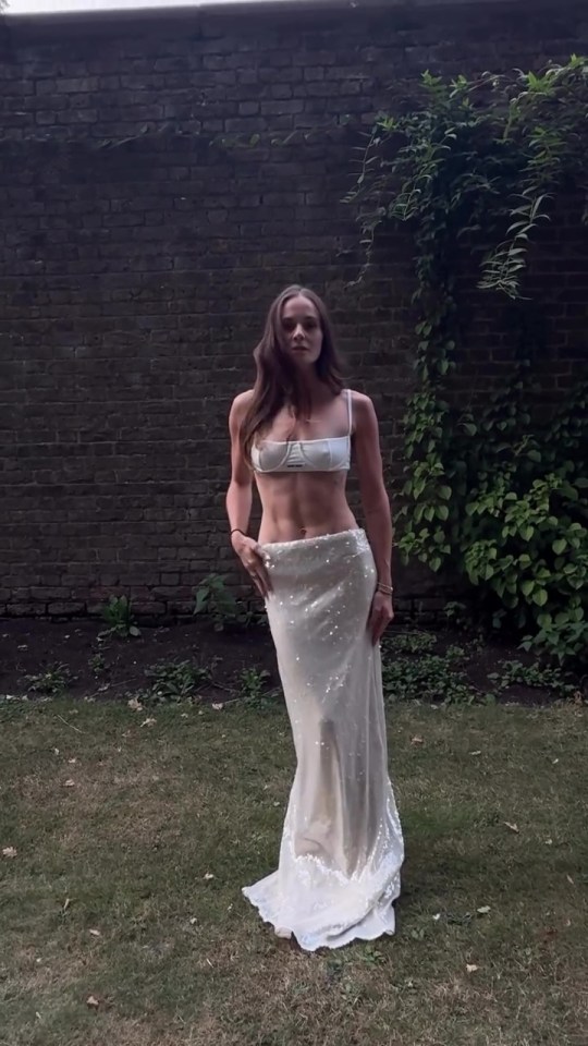 Holly Ramsay in a white bridal-inspired crop top and sequined skirt.