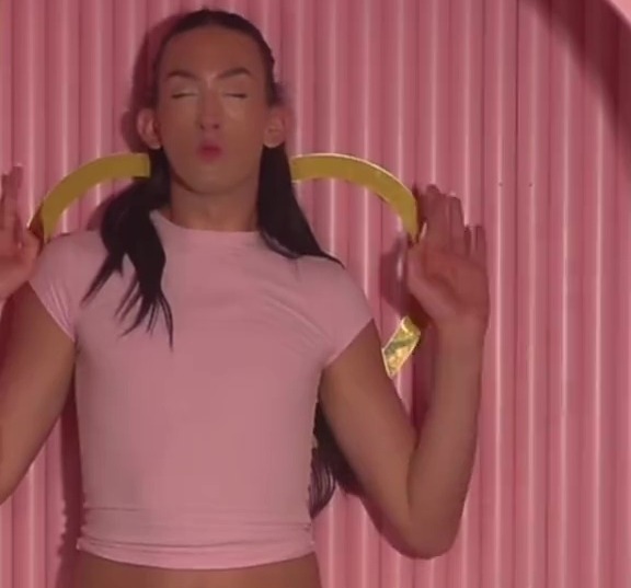 Person in pink shirt and white pants in a pink room asking why P Louise lives are so messy.