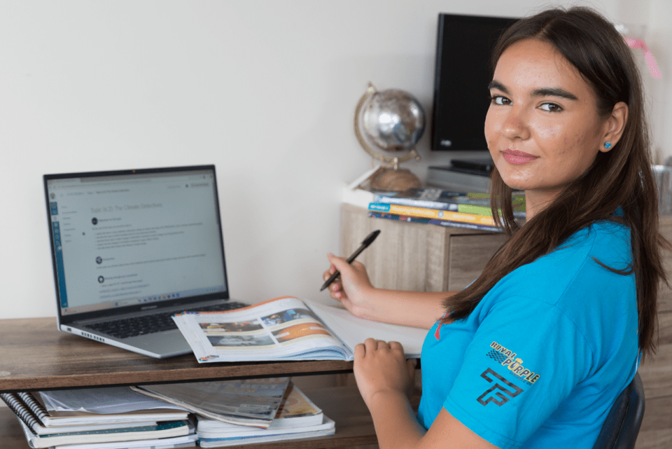 Teenage girl studying at her desk.
