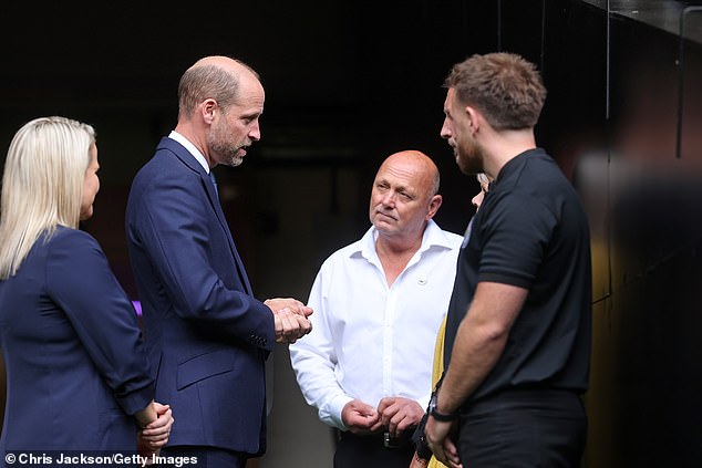 William talks to Jesse Lewis, father of Jac Lewis, and teammates from the late footballer's team Ammanford FC during his visit to Cardiff on World Suicide Prevention Day today