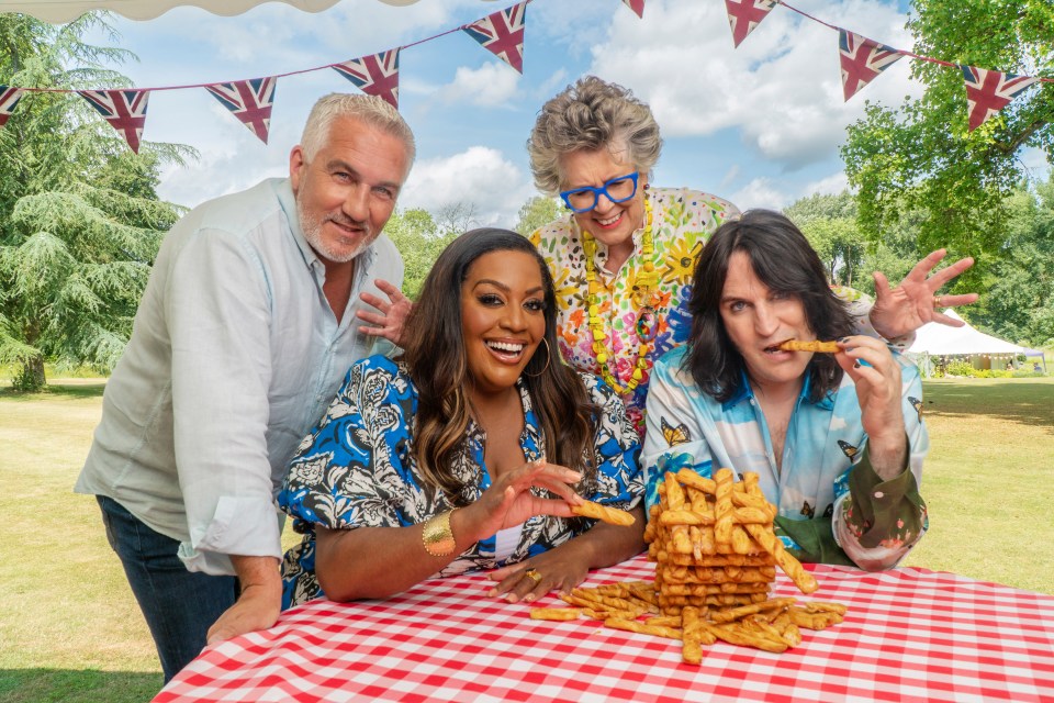 Paul Hollywood, Alison Hammond, Prue Leith, and Noel Fielding with a large pile of breadsticks.