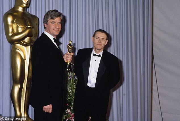 Stuart holding his Best Art Direction award in the press room of the 61st Academy Awards (right is actor Willem Dafoe)