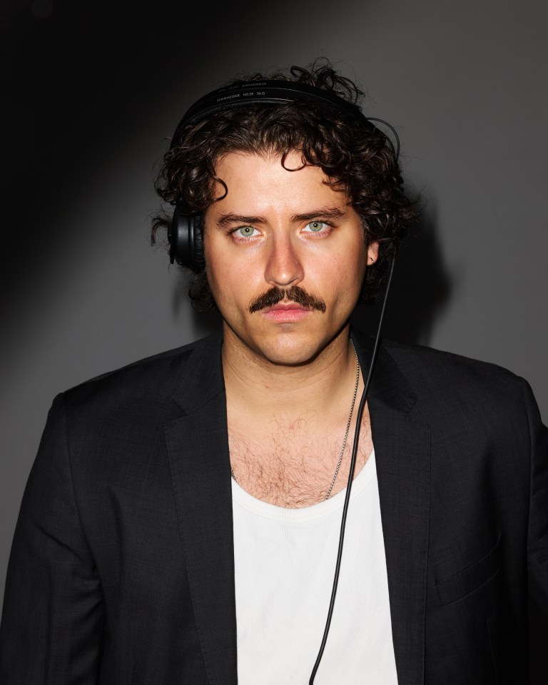 Portrait of Kozlow, a Brooklyn-based artist, wearing headphones.