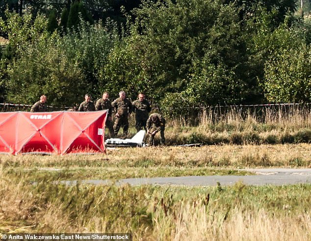 An area was cordoned off as investigators inspected parts of a discovered drone in Mnishkov