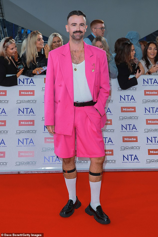 Christiaan de Vries turned heads in a bright pink blazer and shorts combo, accessorised with baffling black leather leg bands