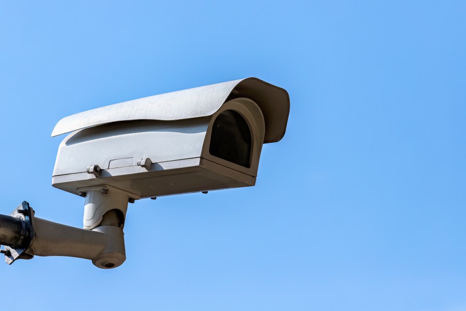 Security camera against a blue sky.