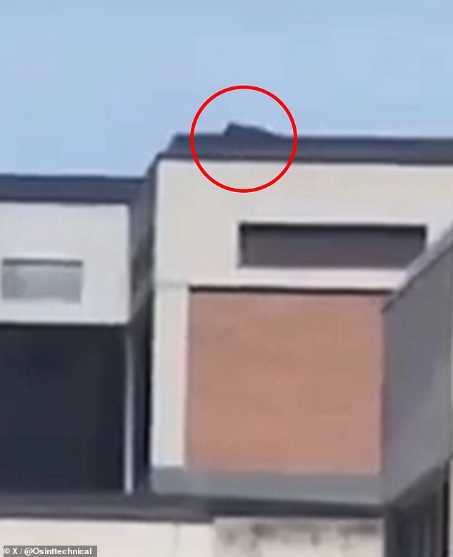 In the new video footage shared on X, a figure is seen lying flat and motionless on the roof of the Losee Center - roughly 200 yards from Kirk - just moments before the shot rang out (pictured)