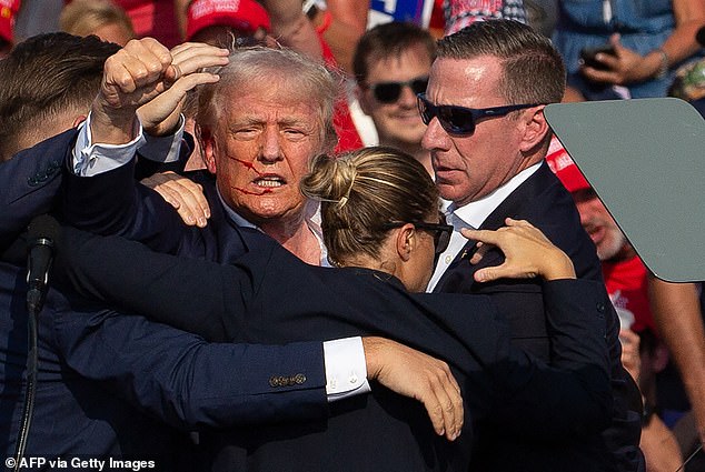 Kirk, a devout Christian, said at the time that Trump was saved by divine intervention, suggesting a 'gust of wind' may have 'pushed that bullet ever so slightly' (Pictured: Trump rushed off Butler, PA stage on July 13, 2025)