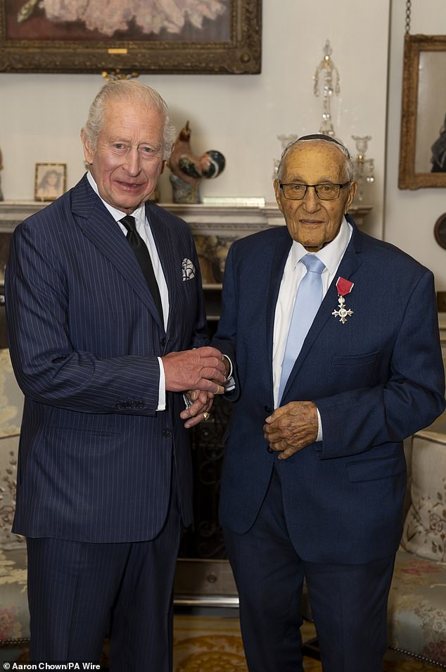 The King met with Holocaust survivor Manfred Goldberg (right) to invest him with an MBE