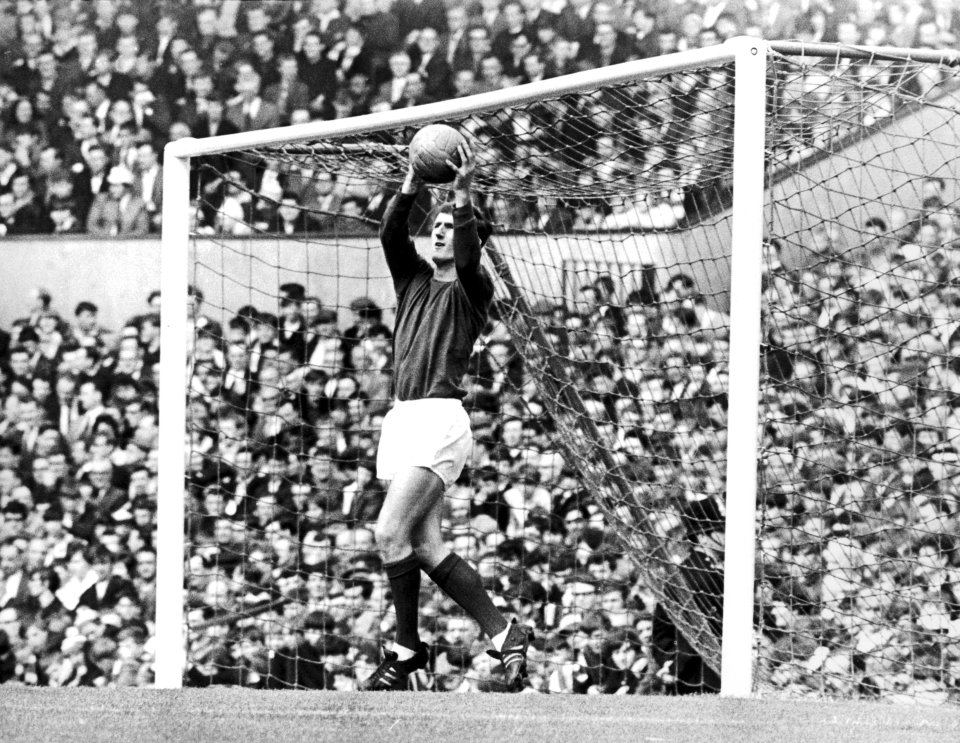 Alex Stepney, Manchester United's goalkeeper, making a catch.