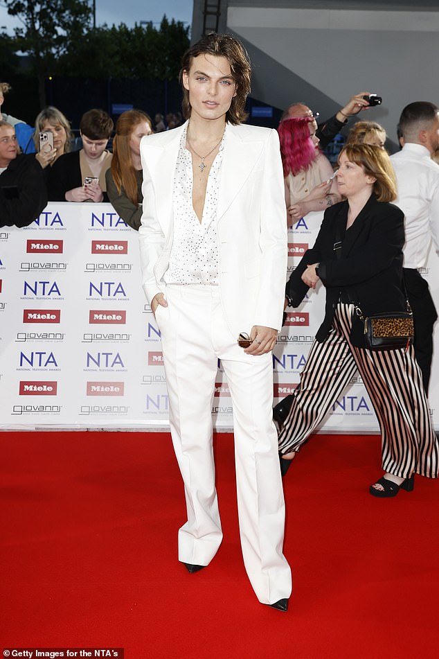 Damian, 23, posed up a storm in an attention-grabbing white suit paired with a satin shirt