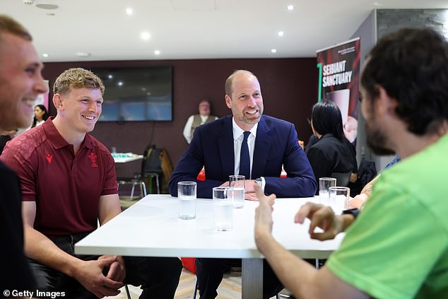 Prince William talks to members of the Welsh Rugby Union during his visit to Cardiff yesterday. The Mail's source believes he will have been informed that his younger brother and father were meeting