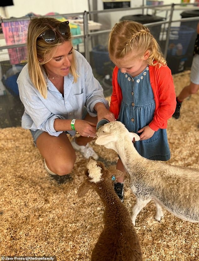 Saving money hadn't even been on their agenda when they first started planning the cross-continental trip, which was inspired by an extended holiday they took to Australia in 2022. Pictured: Hayley with Nyla feeding lambs