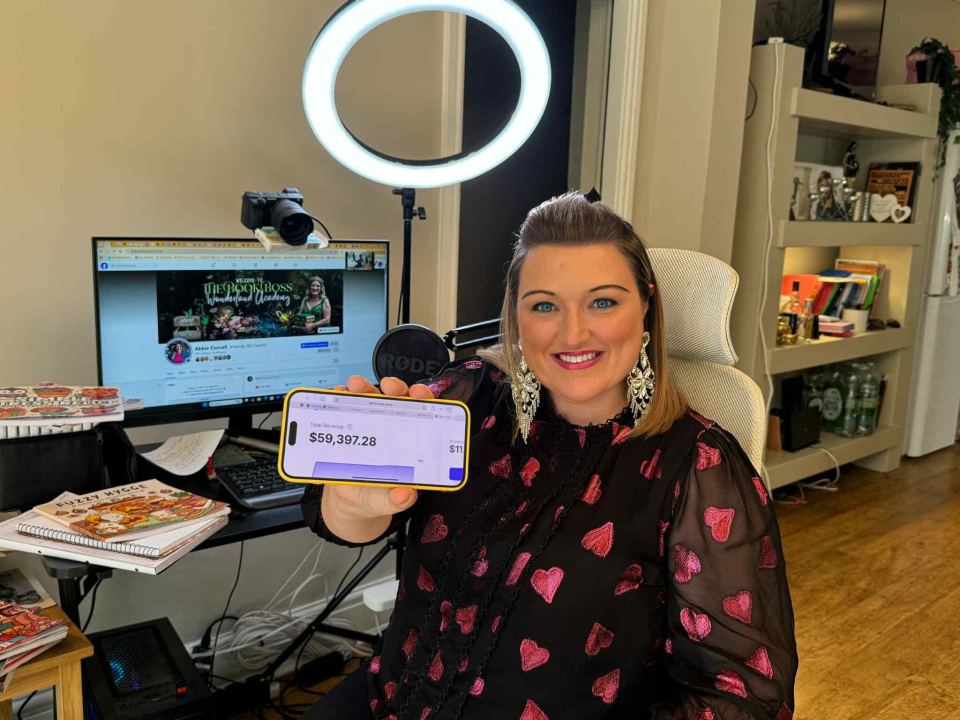 Woman showing phone screen displaying $59,397.28 revenue.