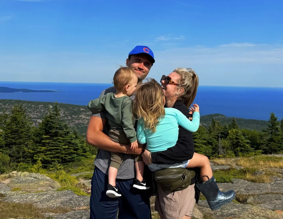 Family photo taken on a mountaintop overlooking the ocean.