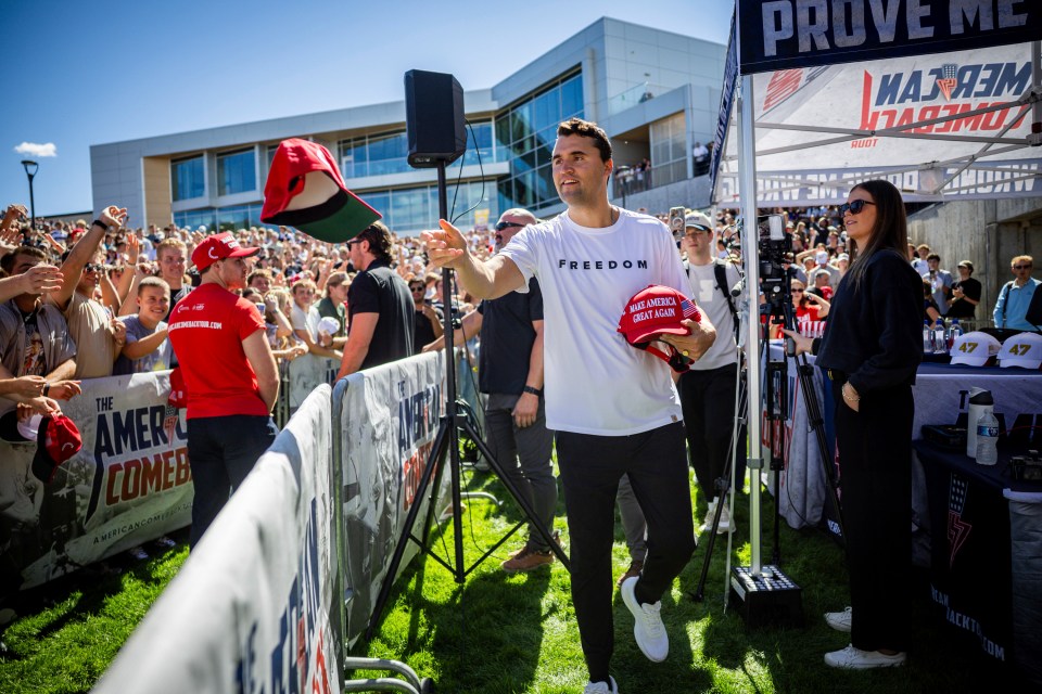 Charlie Kirk throwing hats to a crowd.