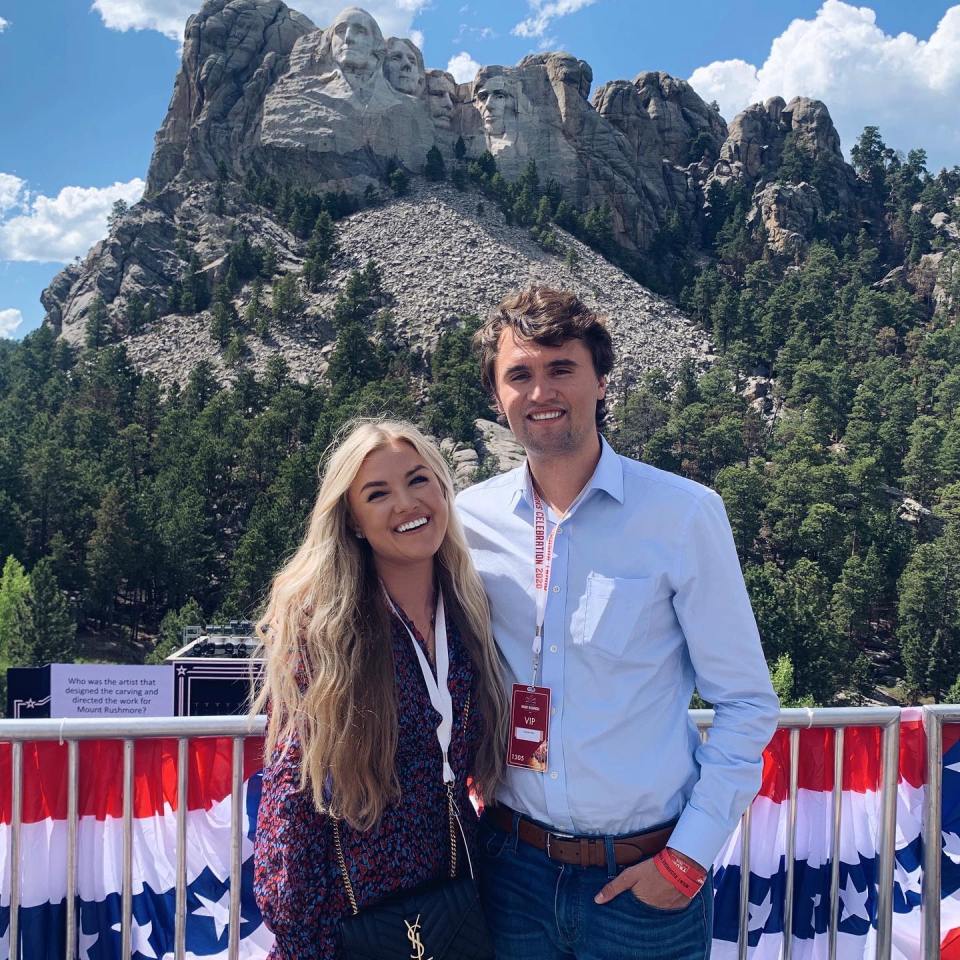 Couple posing in front of Mount Rushmore.