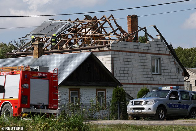Firefighters work on the destroyed roof of a house, after Russian drones violated Polish airspace during an attack on Ukraine, with some being shot down by Poland with the backing from its NATO allies, in Wyryki, Lublin Voivodeship, Poland, September 10, 2025