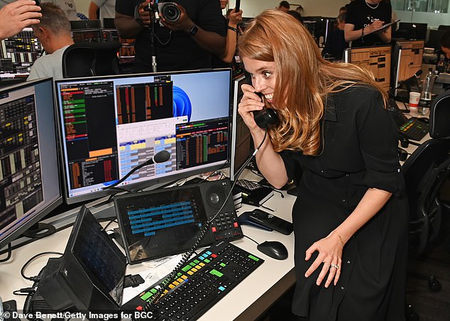 Beatrice was photographed on the trading floor where, under the guidance of brokers, she struck deals with company clients - with 100 per cent of the revenue being donated to her charity
