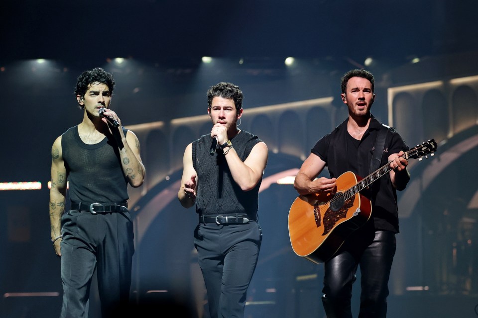 The Jonas Brothers performing on stage.
