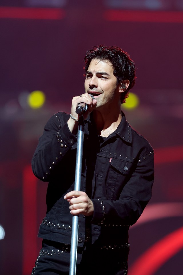 Joe Jonas performing on stage.