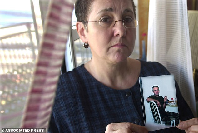 Lucyna Siwiak in January 2002, holding her brother's picture six months after his murder