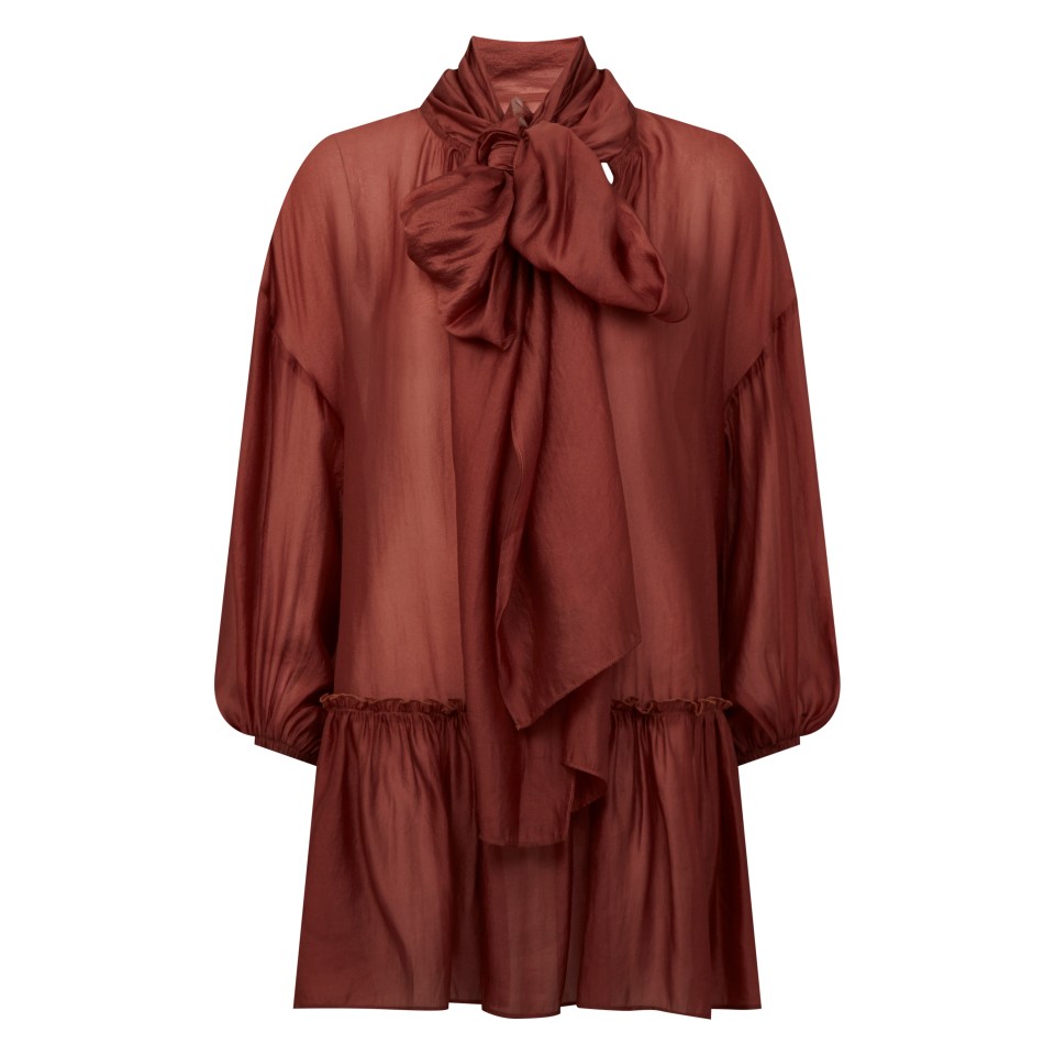 Rust-colored blouse with a bow tie.