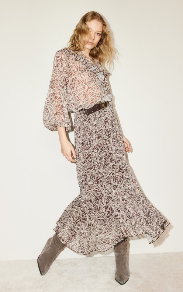 Model wearing a brown and beige patterned dress and boots.