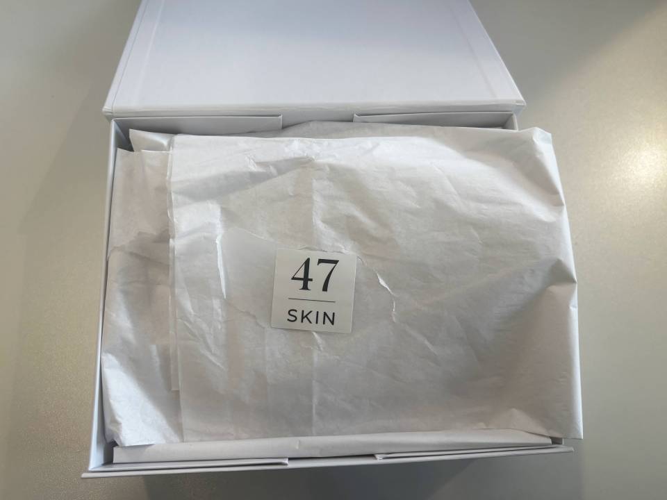 White box with tissue paper, labeled "47 SKIN".
