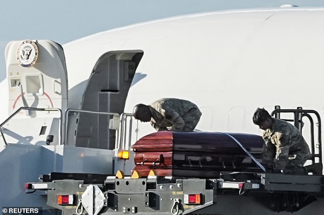 Us Air Force members load Kirk's casket onto Air Force Two