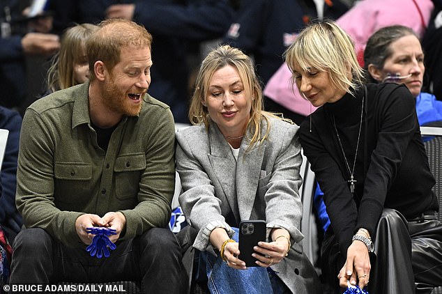 Harry with Olga Rudneva, far right, who invited him to Ukraine. They are pictured together at the Invictus Games in Vancouver in February