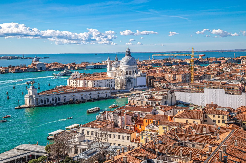 Aerial view of Venice, Italy, showing the Basilica di Santa Maria della Salute and surrounding buildings.