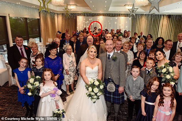 Andrew Hillhouse tried to hide at the back of the group wedding picture