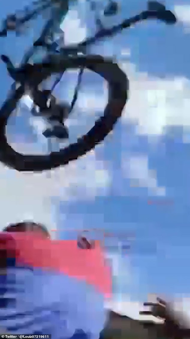 One bike is seen flying through the air as horrified spectators scream dive for protection