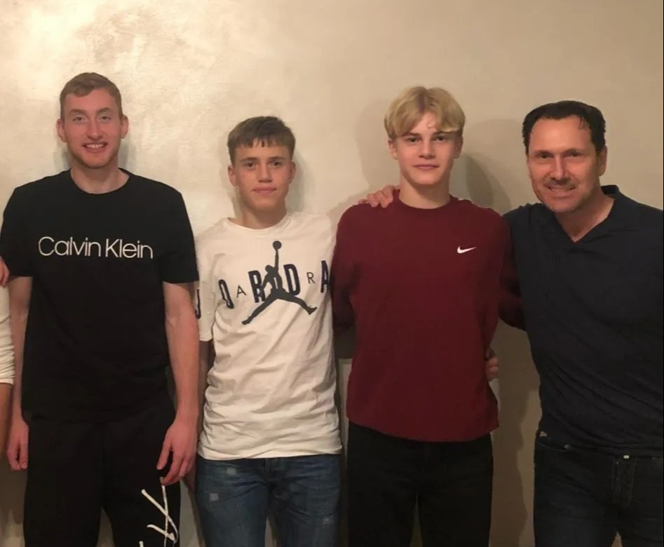 Photo of four people posing for a picture.