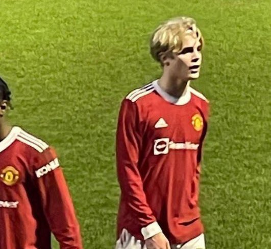 Soccer player in Manchester United jersey.