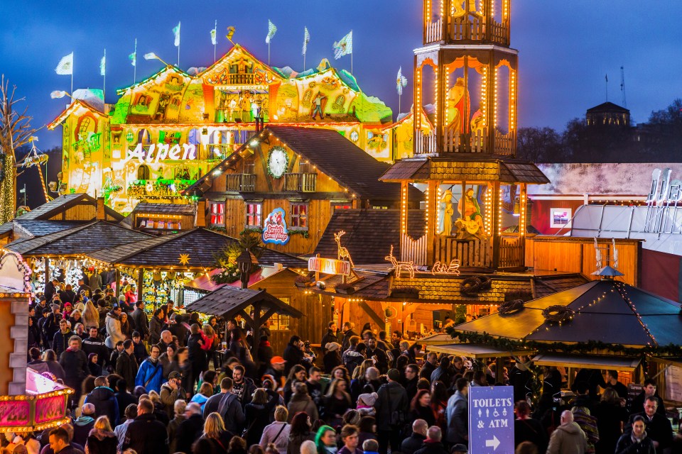Crowded Christmas market at dusk.