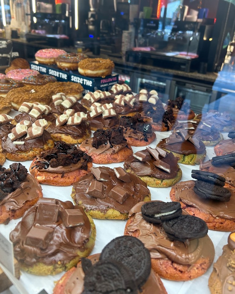 Chocolate cookies topped with various chocolate candies and cookies.