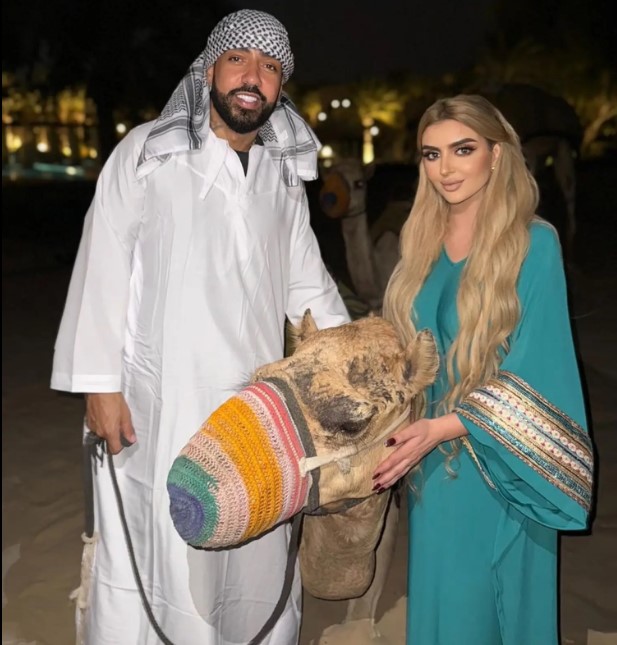 French Montana and Sheikha Mahra with a camel.