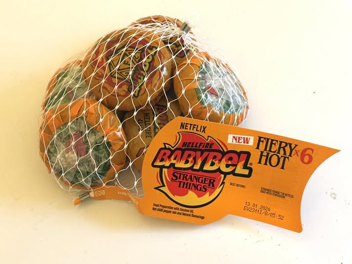 Six spicy Babybel cheeses in a net bag.