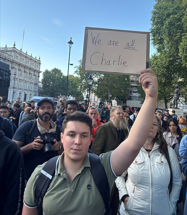 A mourner holds up a sign saying 'We are all Charlie' in London on Friday