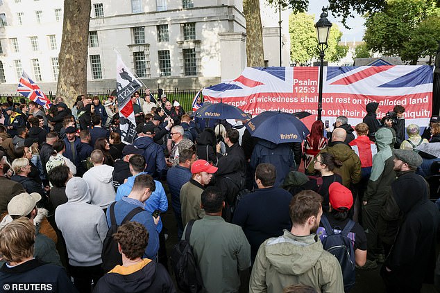 Mourners who gathered despite the showers were seen holding British, American and English flags