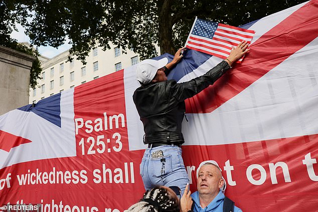 A person holds a U.S. flag during a vigil at the Montgomery Statue in Whitehall
