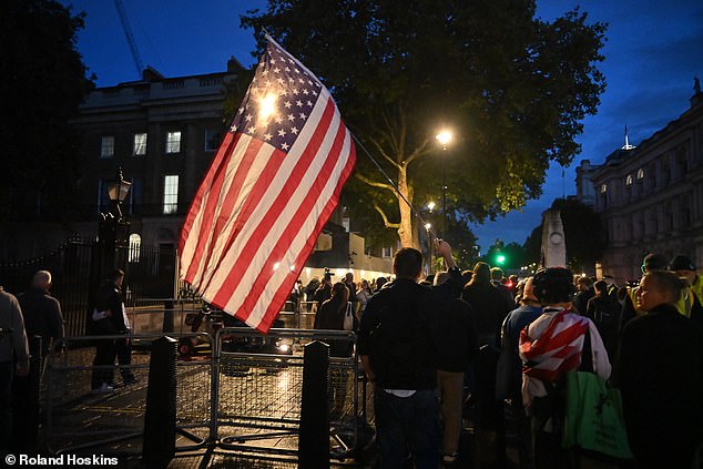 An American flag is flown at Charlie Kirk's vigil in London