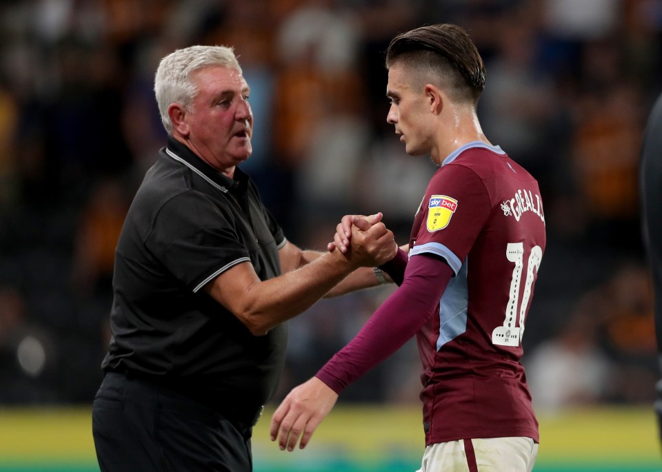 Aston Villa manager Steve Bruce shaking hands with Jack Grealish.