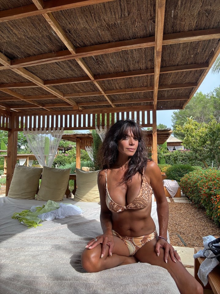 Jenny Powell in a bikini on a sun lounger.
